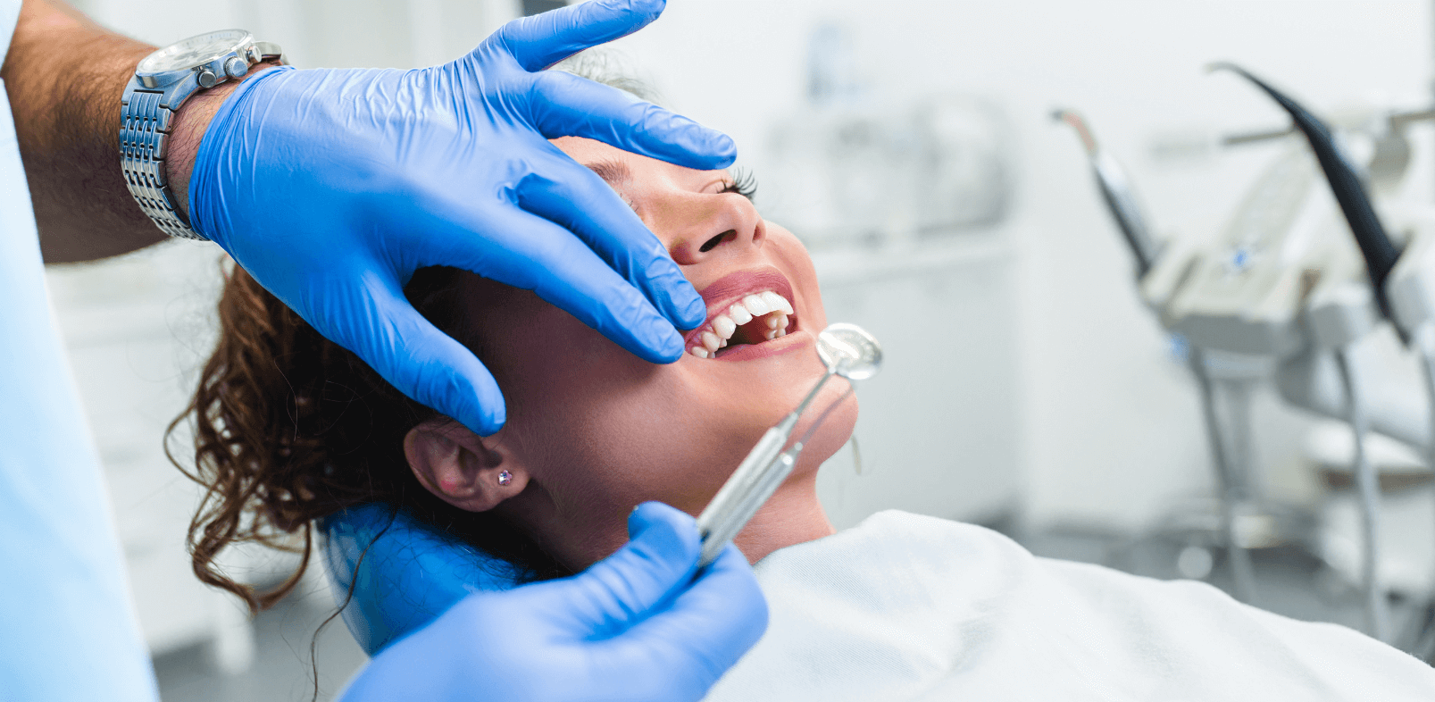 Lady in a dental chair getting a mouth examination at the dentist