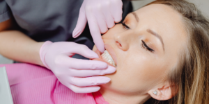 female having gums checked at dentist